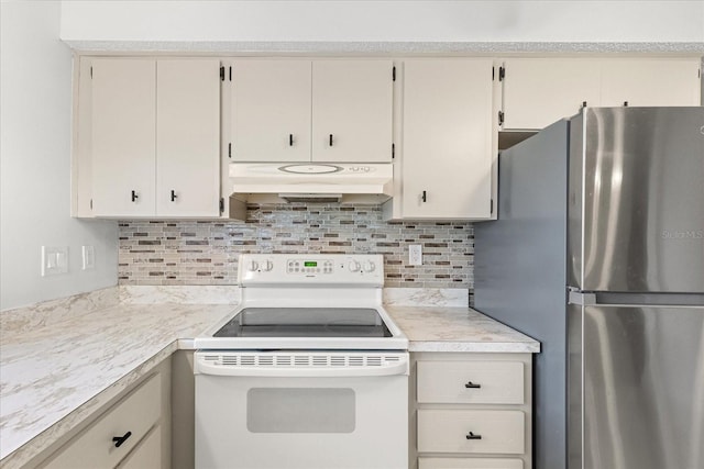 13013 Sawmill Way, Hudson, FL 34667 - kitchen with white range with electric cooktop, freestanding refrigerator, under cabinet range hood, light countertops, and decorative backsplash