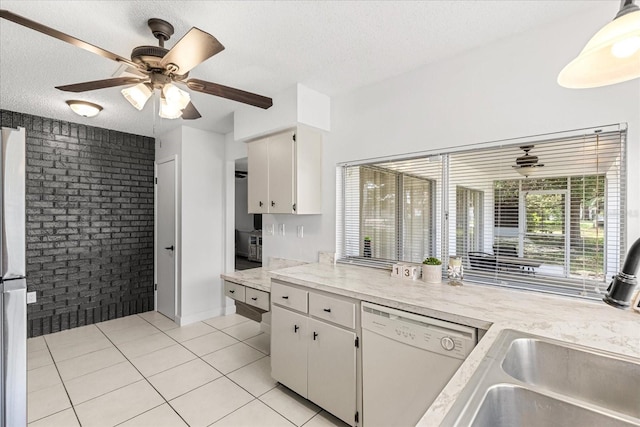 13013 Sawmill Way, Hudson, FL 34667 - kitchen featuring dishwasher, brick wall, a textured ceiling, ceiling fan, and light countertops