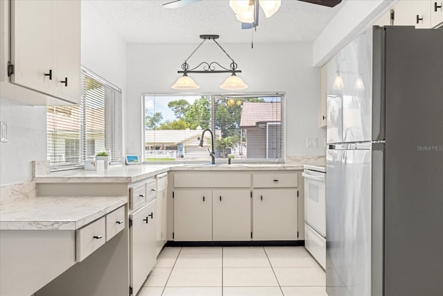 13013 Sawmill Way, Hudson, FL 34667 - kitchen featuring freestanding refrigerator, a sink, light countertops, a ceiling fan, and white stove