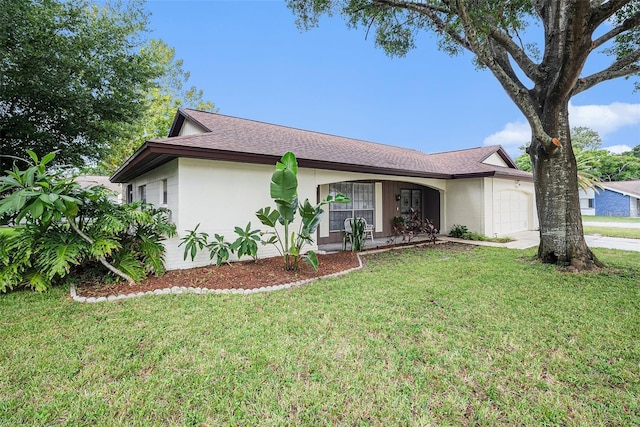 13013 Sawmill Way, Hudson, FL 34667 - view of front of home featuring an attached garage, driveway, a front lawn, and roof with shingles