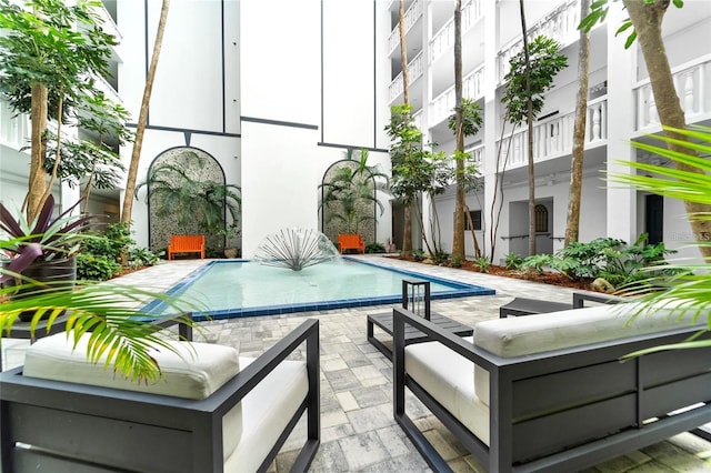 4950 Gulf Blvd Unit 404, St Pete Beach, FL 33706 - swimming pool with a patio and outdoor lounge area