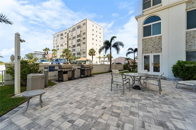 4950 Gulf Blvd Unit 404, St Pete Beach, FL 33706 - view of patio / terrace featuring a grill and french doors