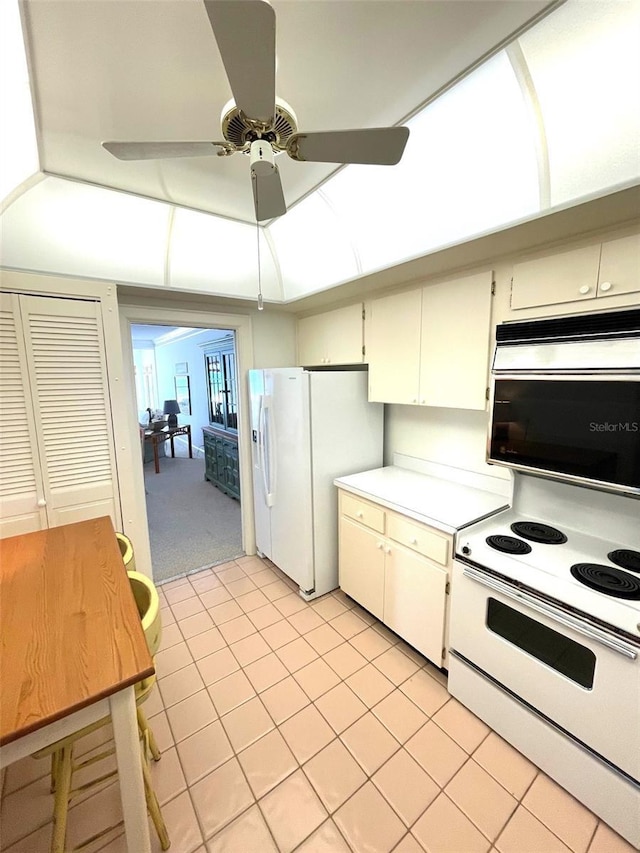 4950 Gulf Blvd Unit 404, St Pete Beach, FL 33706 - kitchen featuring white appliances, ceiling fan, light countertops, and light tile patterned floors