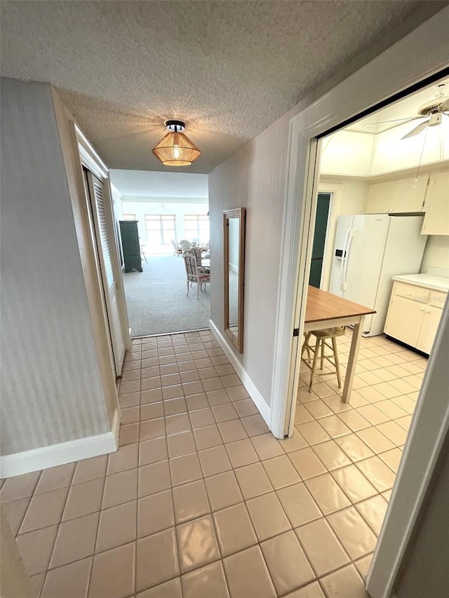 4950 Gulf Blvd Unit 404, St Pete Beach, FL 33706 - hallway with light tile patterned flooring and a textured ceiling