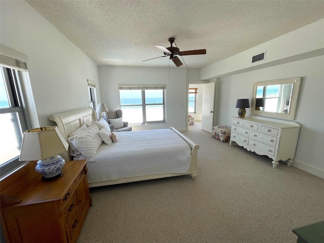 4950 Gulf Blvd Unit 404, St Pete Beach, FL 33706 - carpeted bedroom with multiple windows, a textured ceiling, and a ceiling fan