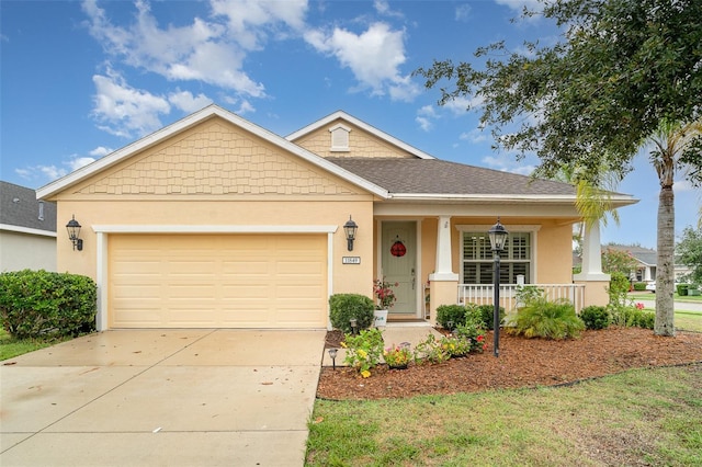 11849 Forest Park Cir, Bradenton, FL 34211 - view of front of home featuring covered porch, an attached garage, stucco siding, and driveway