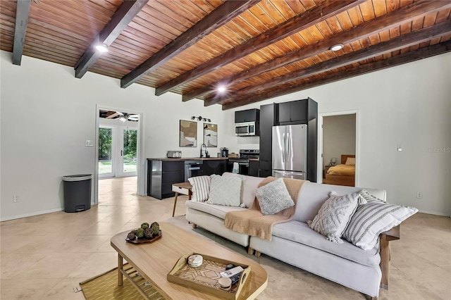 8944 W White Dogwood Dr, Homosassa, FL 34448 - living area featuring wood ceiling with exposed beams, a ceiling fan, light tile patterned flooring, and baseboards