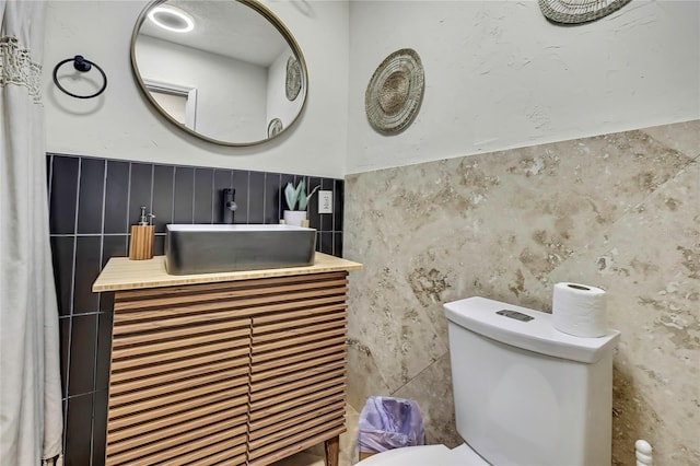 8944 W White Dogwood Dr, Homosassa, FL 34448 - half bath with vanity, tile walls, toilet, and wainscoting