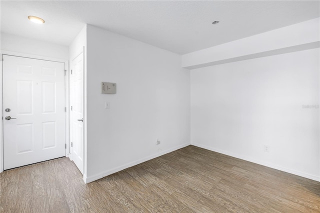 3305 Haviland Ct Unit 101, Palm Harbor, FL 34684 - empty room featuring wood finished floors and baseboards