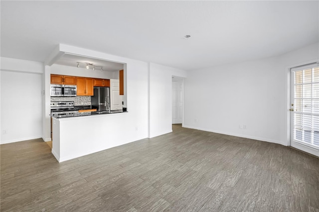 3305 Haviland Ct Unit 101, Palm Harbor, FL 34684 - unfurnished living room featuring wood finished floors and baseboards