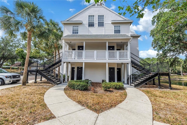 3300 Haviland Ct Unit 103, Palm Harbor, FL 34684 - coastal inspired home featuring stairs and a porch