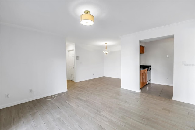 3300 Haviland Ct Unit 103, Palm Harbor, FL 34684 - spare room featuring light wood-style flooring and ornamental molding