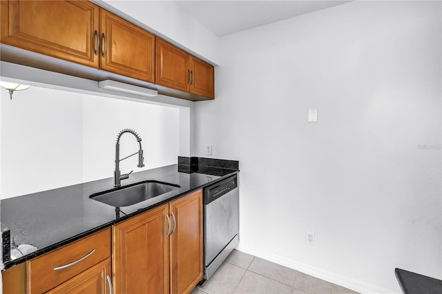 3300 Haviland Ct Unit 103, Palm Harbor, FL 34684 - kitchen featuring dishwasher, brown cabinetry, light tile patterned floors, and dark stone counters