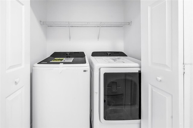 3300 Haviland Ct Unit 103, Palm Harbor, FL 34684 - laundry room with washing machine and dryer
