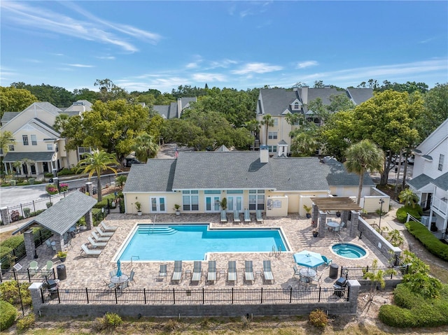 3300 Haviland Ct Unit 103, Palm Harbor, FL 34684 - community pool featuring a community hot tub, a patio, a residential view, and a pergola