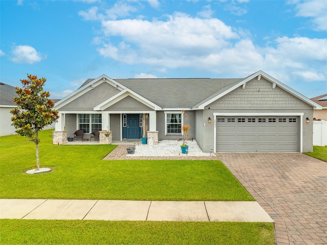 2053 Charleston Ln, Bartow, FL 33830 - craftsman inspired home featuring decorative driveway, a garage, stucco siding, a front lawn, and a porch