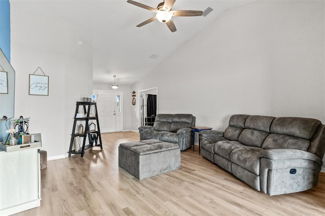 2053 Charleston Ln, Bartow, FL 33830 - living room with ceiling fan, high vaulted ceiling, light wood-style flooring, and baseboards