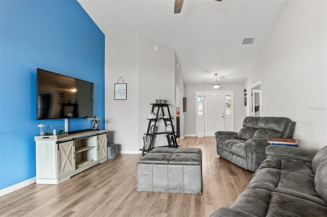 2053 Charleston Ln, Bartow, FL 33830 - living room featuring a ceiling fan, light wood-style flooring, baseboards, and lofted ceiling