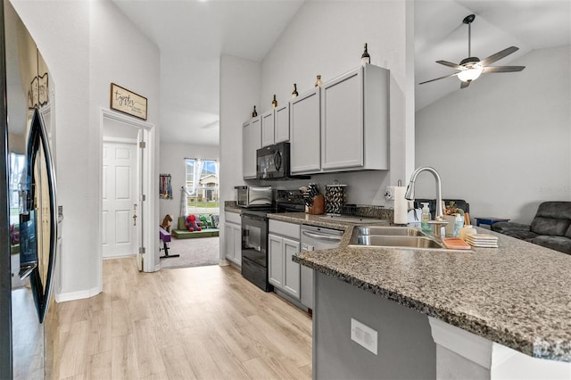 2053 Charleston Ln, Bartow, FL 33830 - kitchen with a sink, black appliances, light wood-type flooring, ceiling fan, and high vaulted ceiling