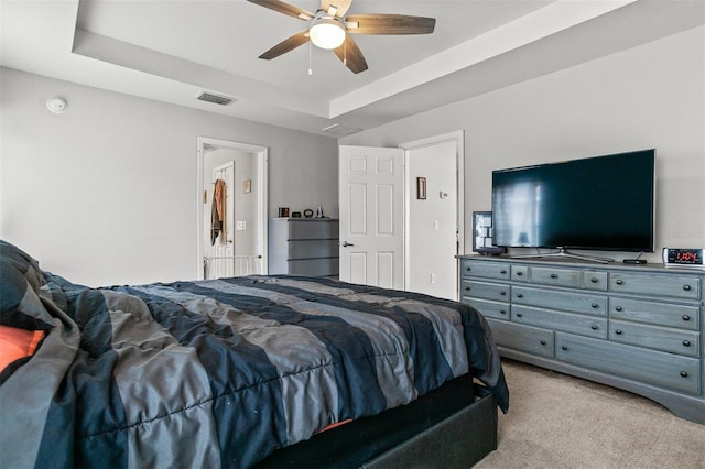 2053 Charleston Ln, Bartow, FL 33830 - carpeted bedroom with a tray ceiling and a ceiling fan
