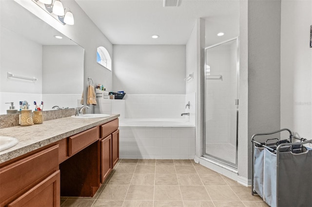 2053 Charleston Ln, Bartow, FL 33830 - bathroom with a garden tub, double vanity, a stall shower, tile patterned flooring, and recessed lighting