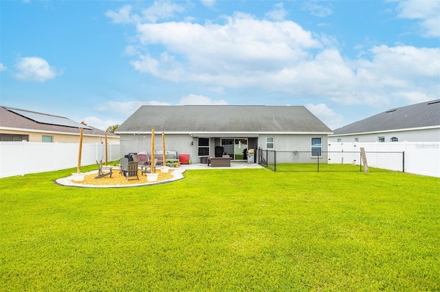 2053 Charleston Ln, Bartow, FL 33830 - rear view of house with a patio area and an outdoor fire pit