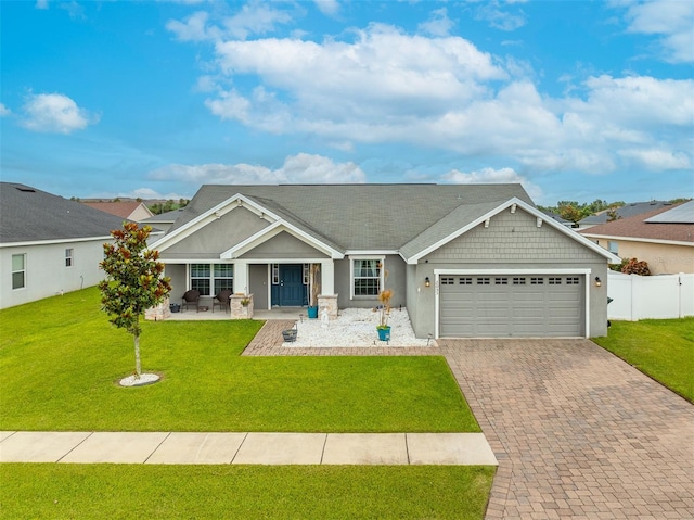 2053 Charleston Ln, Bartow, FL 33830 - craftsman-style home with an attached garage, decorative driveway, and stucco siding