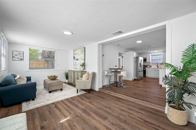 4626 8th Ave S, Saint Petersburg, FL 33711 - living area featuring dark wood-type flooring, recessed lighting, baseboards, and a textured ceiling