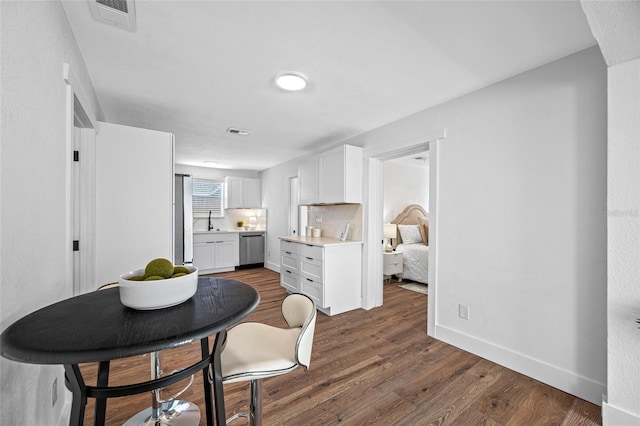 4626 8th Ave S, Saint Petersburg, FL 33711 - dining space with dark wood-type flooring and baseboards