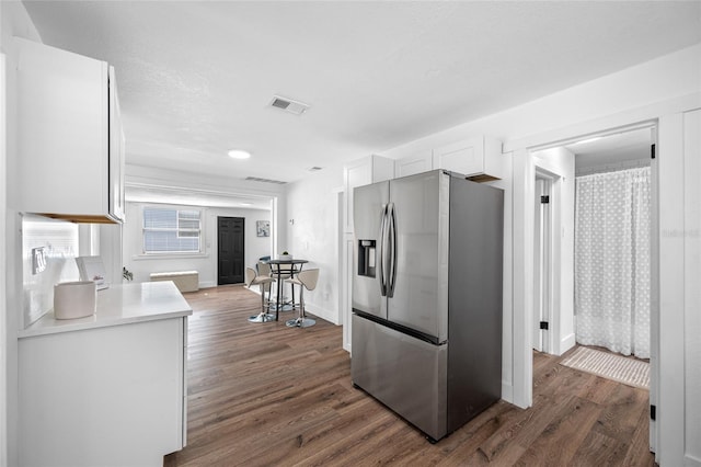 4626 8th Ave S, Saint Petersburg, FL 33711 - kitchen featuring stainless steel fridge with ice dispenser, dark wood-style floors, white cabinetry, and light countertops