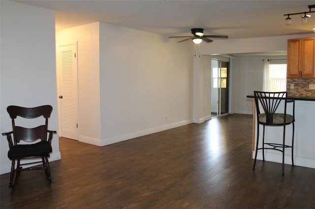 9705 45th Way N, Pinellas Park, FL 33782 - kitchen with a ceiling fan, dark wood finished floors, brown cabinets, and baseboards