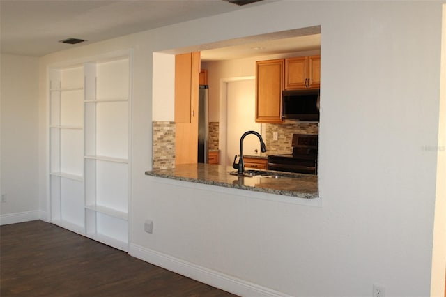 9705 45th Way N, Pinellas Park, FL 33782 - kitchen with appliances with stainless steel finishes, baseboards, a sink, decorative backsplash, and dark wood-style flooring