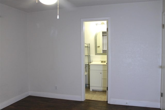 9705 45th Way N, Pinellas Park, FL 33782 - empty room with wood finished floors, a ceiling fan, baseboards, and a sink