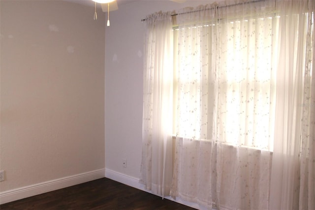 9705 45th Way N, Pinellas Park, FL 33782 - empty room featuring baseboards, dark wood finished floors, and a ceiling fan