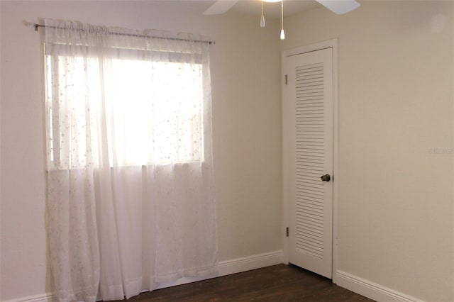 9705 45th Way N, Pinellas Park, FL 33782 - spare room featuring plenty of natural light, ceiling fan, baseboards, and dark wood-style flooring
