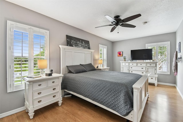 3673 Fremantle Dr, Palm Harbor, FL 34684 - bedroom featuring light wood-style floors, a ceiling fan, and a textured ceiling