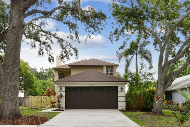 3673 Fremantle Dr, Palm Harbor, FL 34684 - traditional-style house with driveway, stucco siding, a garage, and roof with shingles