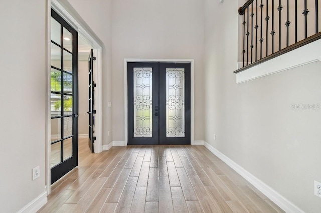 6129 Marsh Trail Dr, Odessa, FL 33556 - foyer with french doors, wood finished floors, baseboards, and a high ceiling