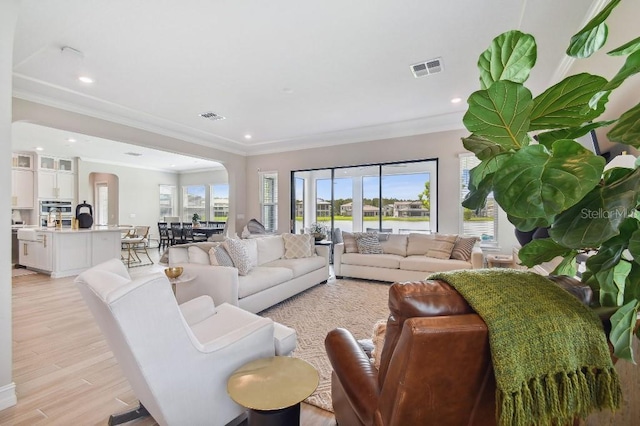 6129 Marsh Trail Dr, Odessa, FL 33556 - living room with ornamental molding, light wood-style flooring, recessed lighting, and a water view