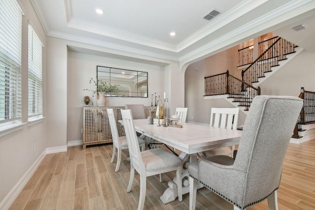 6129 Marsh Trail Dr, Odessa, FL 33556 - dining space featuring healthy amount of natural light, light wood finished floors, stairway, baseboards, and crown molding