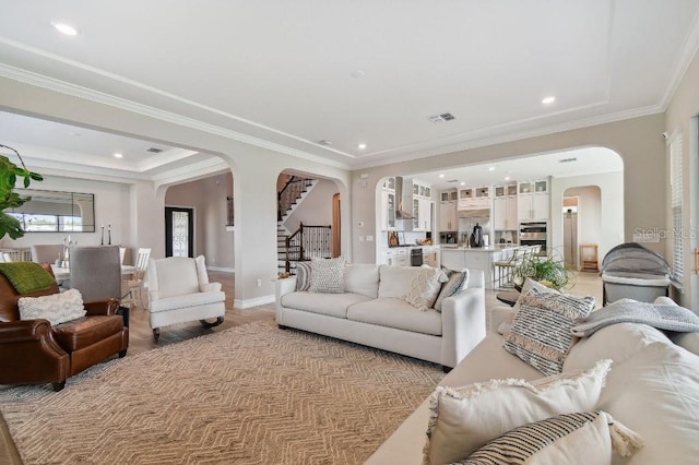 6129 Marsh Trail Dr, Odessa, FL 33556 - living room featuring arched walkways, stairway, ornamental molding, recessed lighting, and baseboards