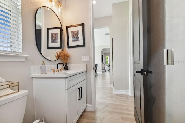 6129 Marsh Trail Dr, Odessa, FL 33556 - bathroom with vanity, wood finished floors, toilet, and baseboards
