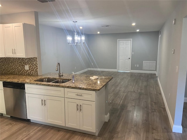 2160 Corbin Pl Unit C, Palm Harbor, FL 34683 - kitchen with stainless steel dishwasher, a peninsula, stone counters, dark wood-style floors, and white cabinetry