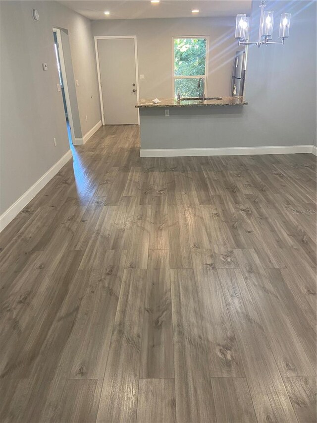 2160 Corbin Pl Unit C, Palm Harbor, FL 34683 - unfurnished living room featuring a chandelier, dark wood-style floors, and recessed lighting