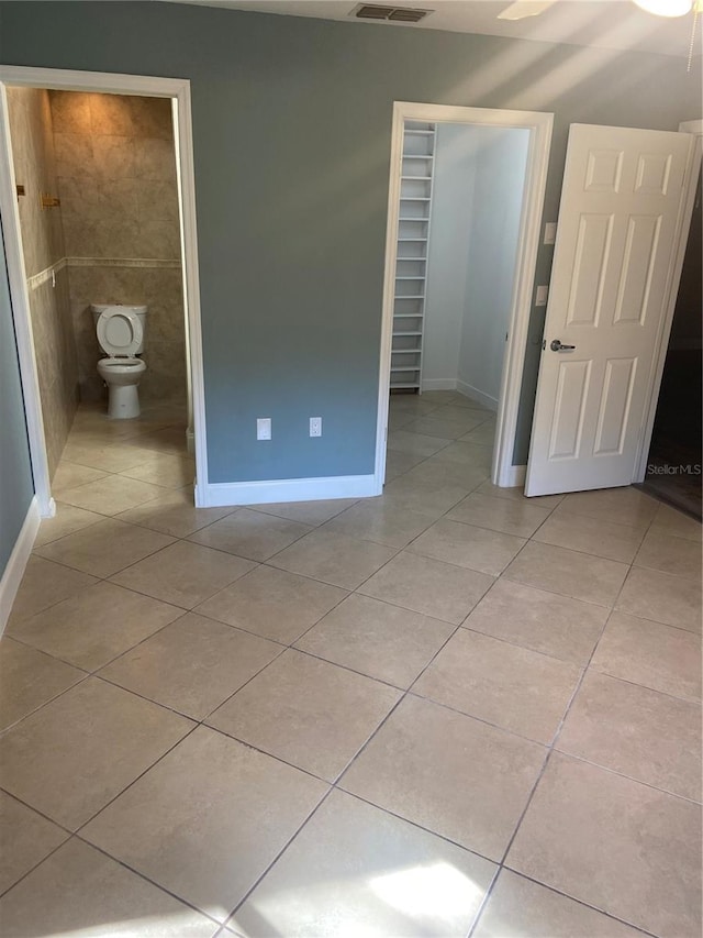 2160 Corbin Pl Unit C, Palm Harbor, FL 34683 - unfurnished bedroom featuring light tile patterned floors, a closet, and ensuite bath
