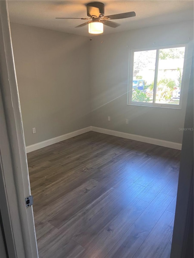 2160 Corbin Pl Unit C, Palm Harbor, FL 34683 - spare room featuring dark wood-style flooring and a ceiling fan