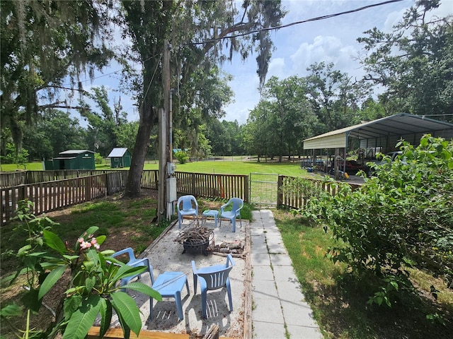 4352 Joy Dr, Land O Lakes, FL 34638 - view of patio with a fire pit and a carport