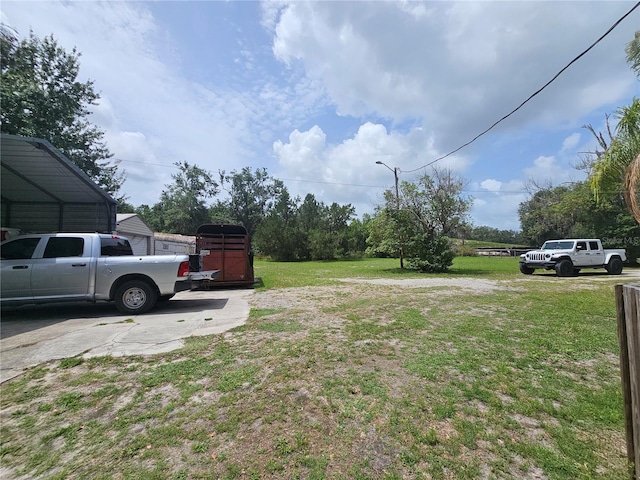 4352 Joy Dr, Land O Lakes, FL 34638 - view of grassy yard featuring a carport