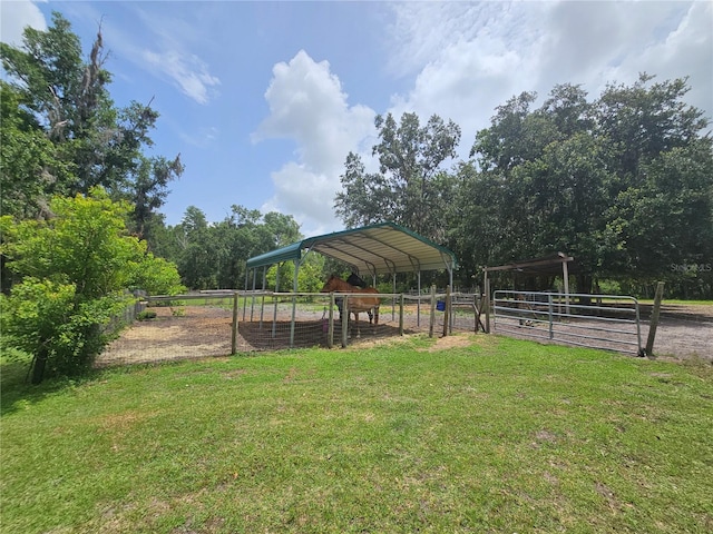 4352 Joy Dr, Land O Lakes, FL 34638 - view of yard featuring an exterior structure, a carport, and an outbuilding