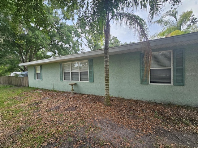 4352 Joy Dr, Land O Lakes, FL 34638 - view of side of home featuring stucco siding